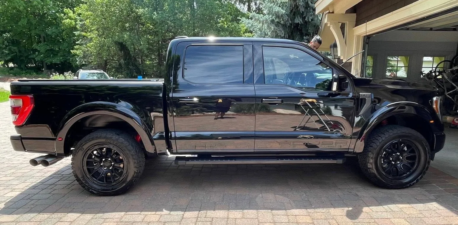 Freshly detailed black truck in a Burnsville, MN driveway